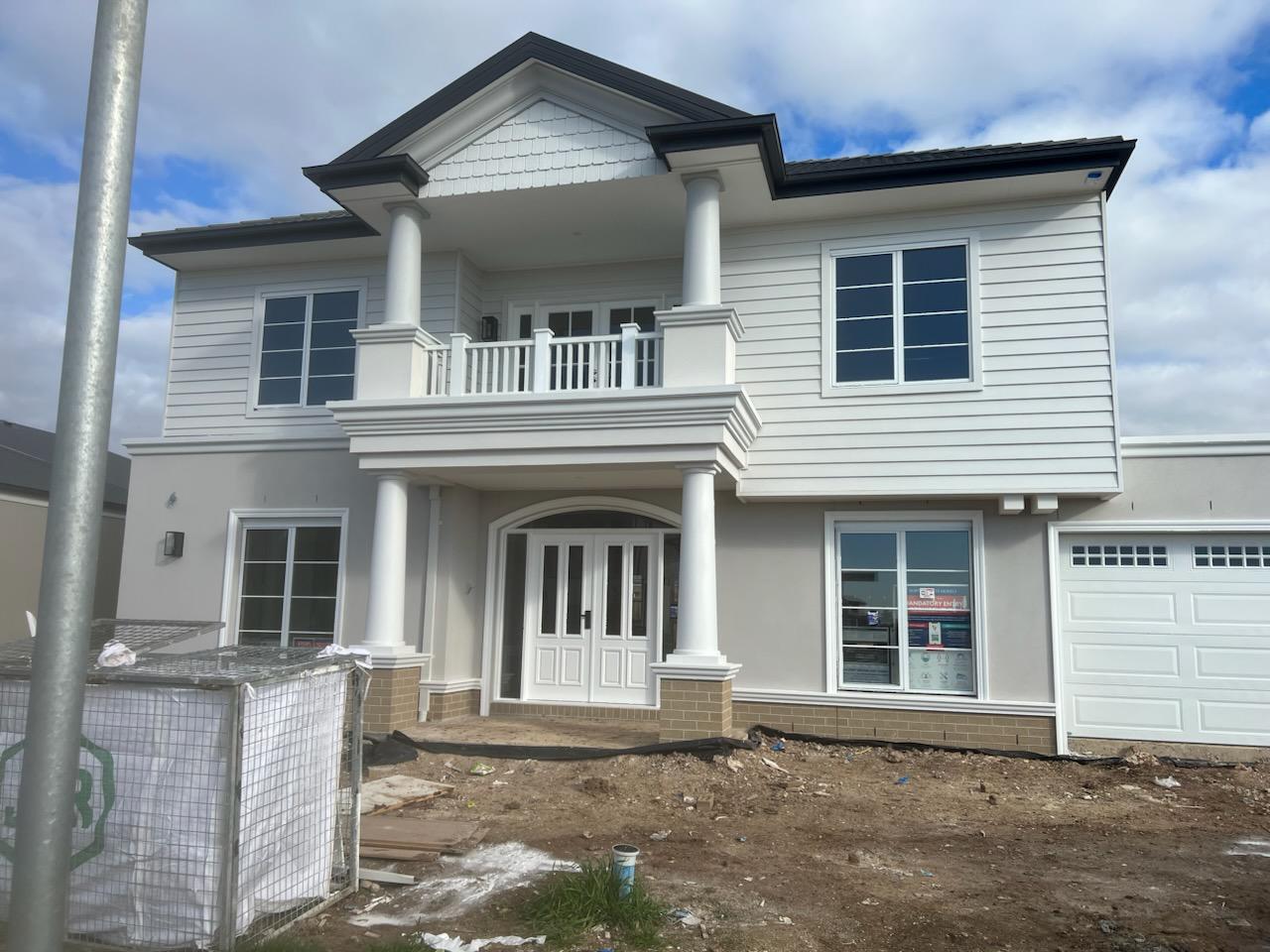 Hamptons style weatherboard home painted white with detailed columns and balustrade