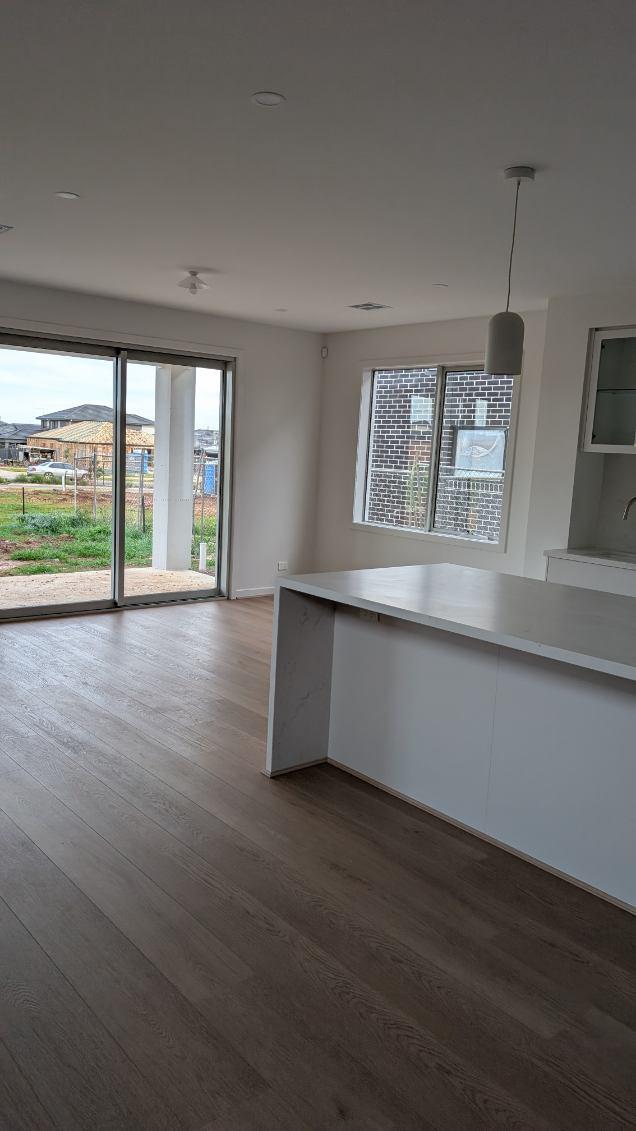 Open plan living and dining room painted in a soft white with matching ceilings